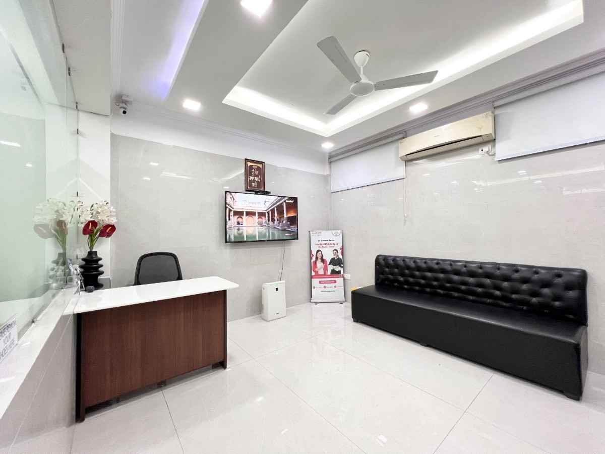 Doctor's cabin with framed degree certificates on wall and consultation desk at Dental World